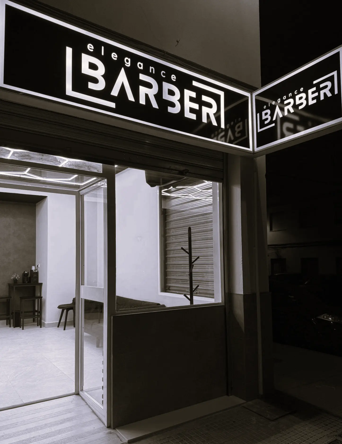 Fachada exterior de Elegance Barber barbería en Ayamonte con rótulo luminoso